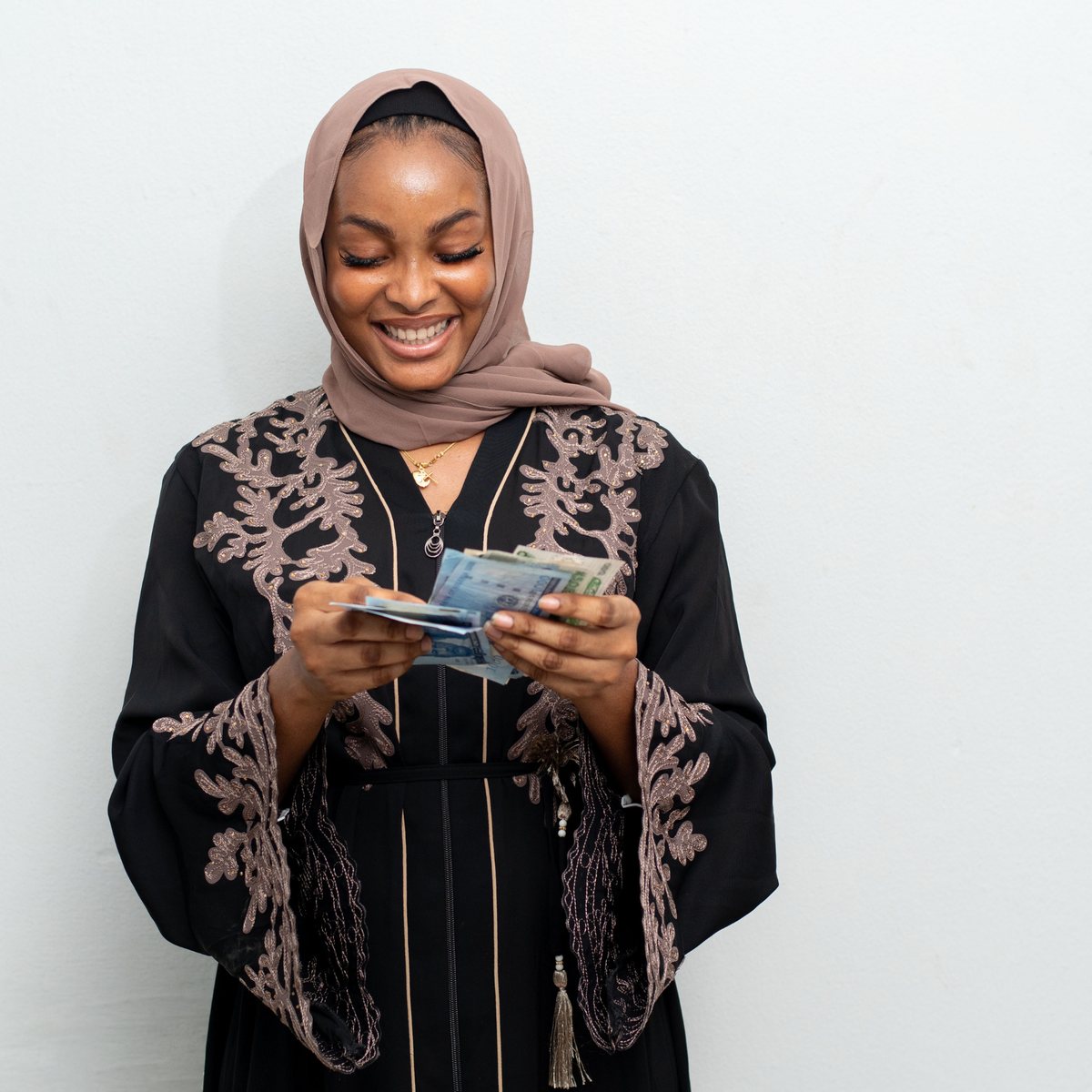 A Nigerian woman photographed against a plain studio backdrop