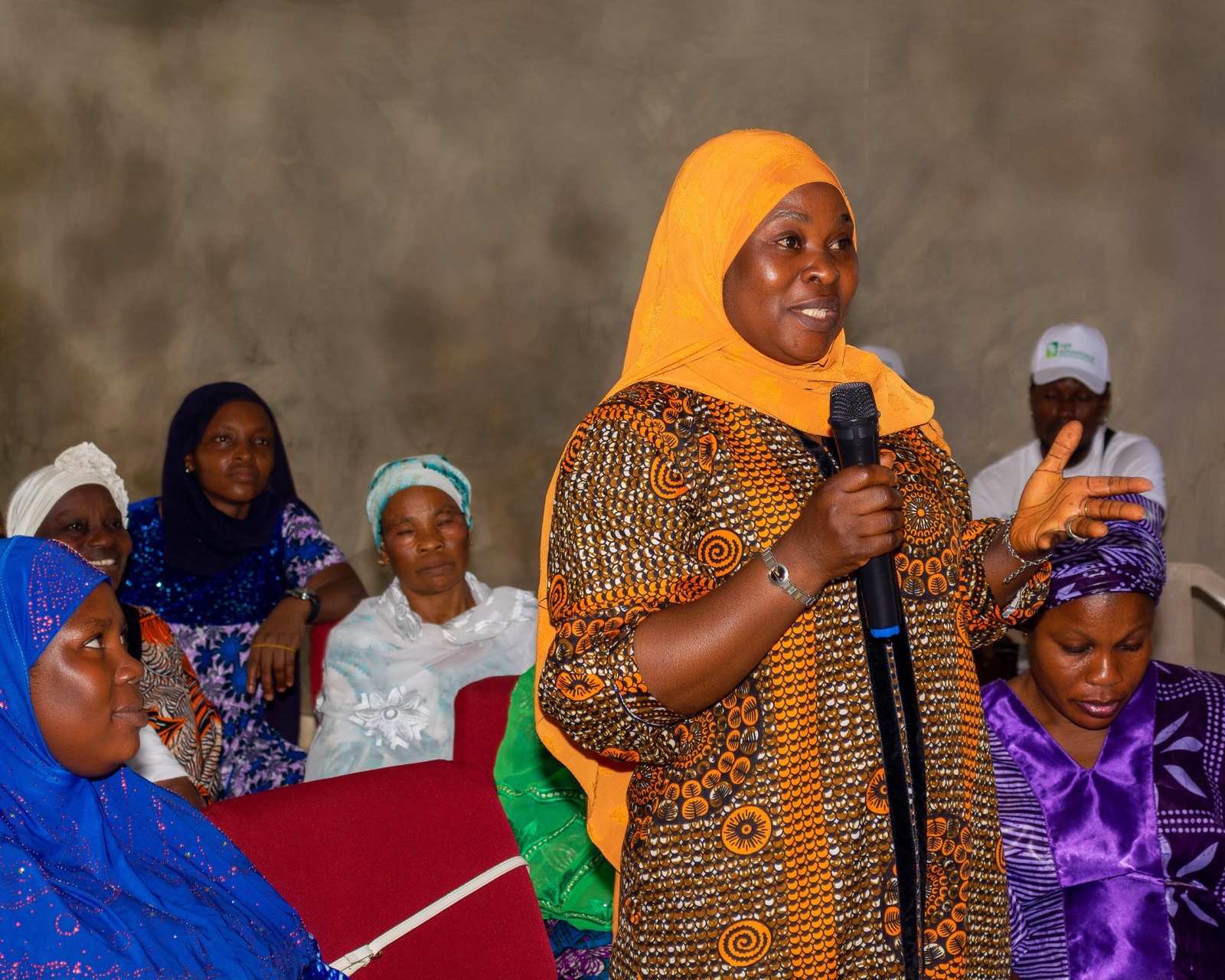 A participant speaking into a microphone at a Her Advantage forum