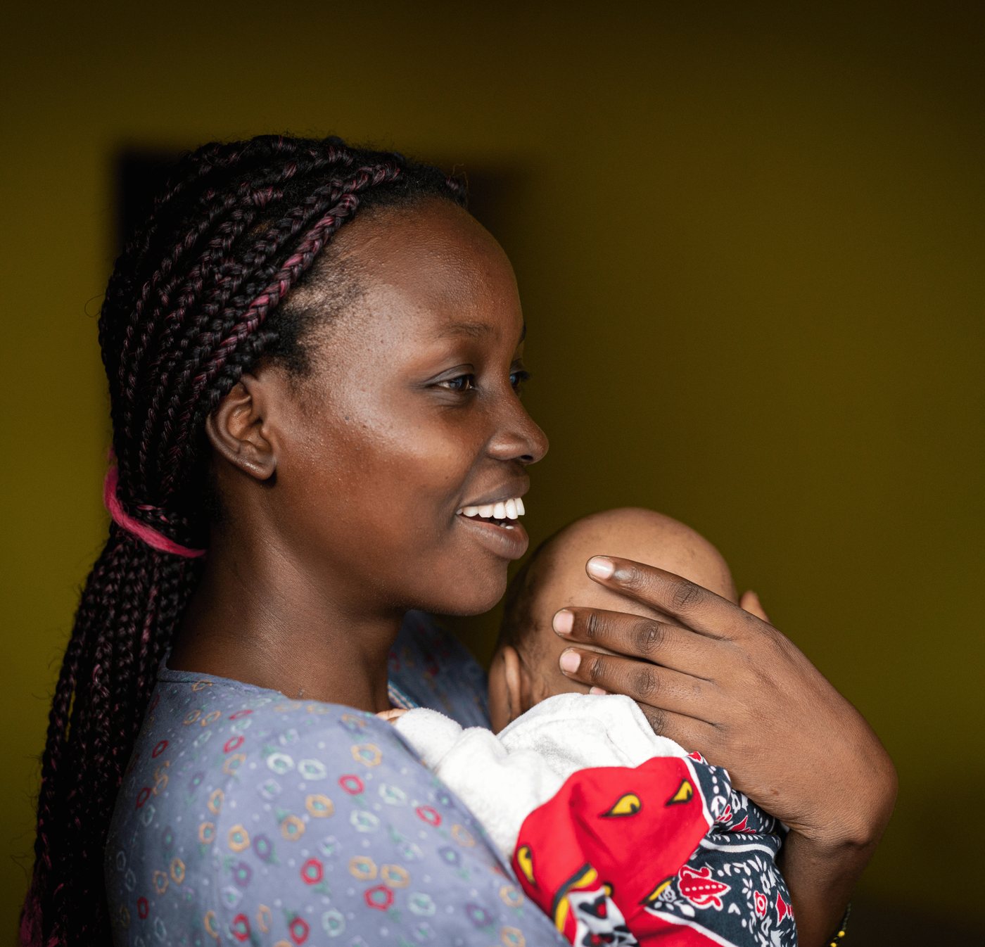 A mother holding her child at a community gathering
